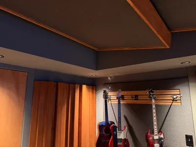 Ceiling acoustic panels and wood trim in the control room, guitars and diffusers below