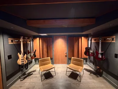Control room looking toward the back wall. Custom wood diffusers, clouds above the mixing area.