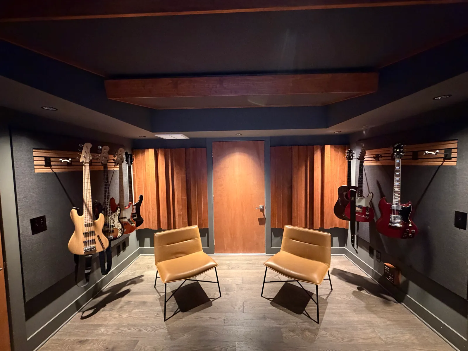 Control room looking toward the back wall. Custom wood diffusers, clouds above the mixing area.